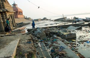 <p>Children clean the ghats of Varanasi free of religious offerings by washing them into the Ganga. (Image by Daniel Bachhuber)</p>