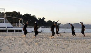 <p>Mime artists enact the plight of the Ganga river dolphin on the edge of the Brahmaputra in Assam. (Image by Aaranyak).</p>