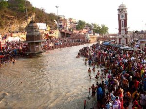 crowds of people surrounding the Ganga river by Barry Silver