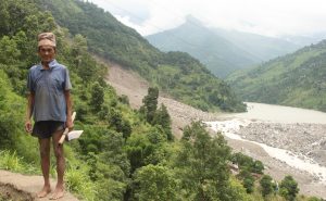 Man standing next to Nepal landslide