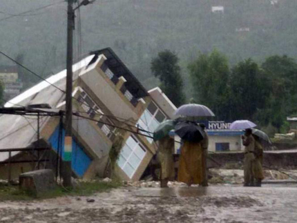 <p>Flood waters wash away the Doru Verinag bridge in Poonch, Jammu and Kashmir (Image by Press Trust of India)</p>