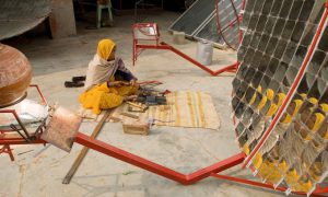 <p>A rural woman-turned solar engineer making a solar cooker to promote cooking with clean fuel (Image by Knut Erik-Helle)</p>