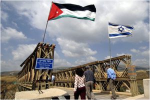 <p>Israeli / Jordanian flags on the wooden bridge over the Yarmouk River (a tributary of the Jordan River) mark the entrance onto the Peace Island. Photo credit: EcoPeace / FoEME</p>