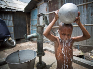 <p>A child washes himself in Kallyanpur, a slum in Bangladesh&#8217;s capital, Dhaka. As of 2006 figures, 1.1 billion people in developing countries have inadequate access to water, while 2.6 billion lack basic sanitation. Image source: United Nations</p>