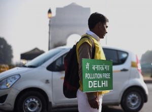 <p>A civil defence volunteer holds a placard in new Delhi (Image: Bi Xiaoyang/Xinhua/Alamy)</p>