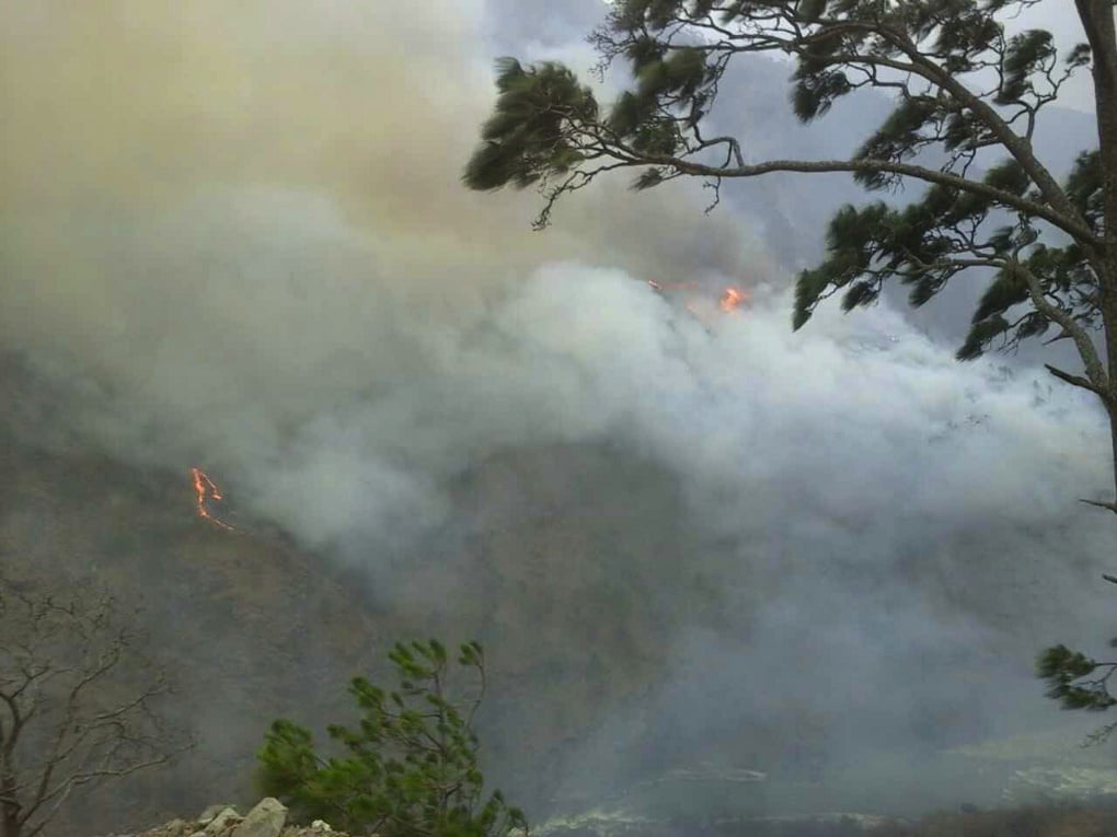 <p>The fire in Wangdue has cloaked the mountains in smoke [image by Dawa Gyelmo]</p>