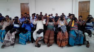 <p>Fishermen being trained on using binoculars to spot dolphins [Image by WCS Bangladesh Program]</p>
