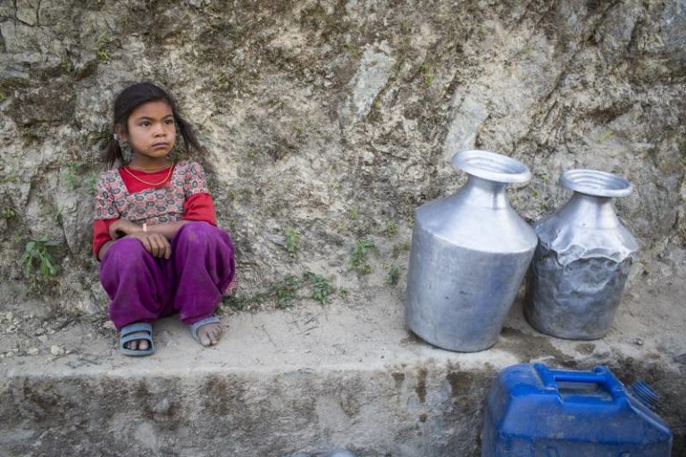 Bishnu Magar awaits her turn to fetch drinking water in Udayapu