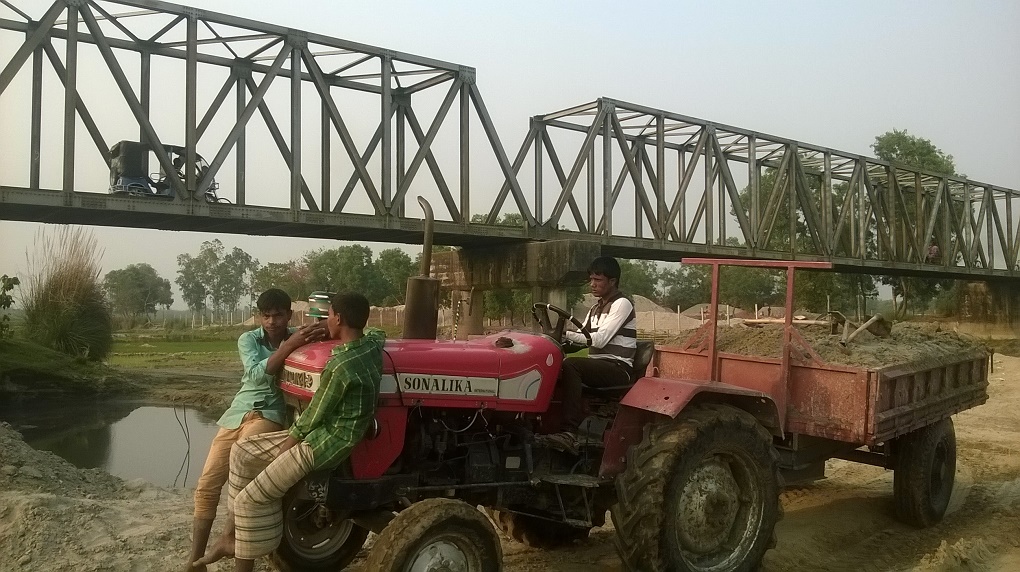 Labourers, allegedly backed by politicians, cart away sand from Jamuneshwari River in Nilphamari [image by Sheikh Rokon]