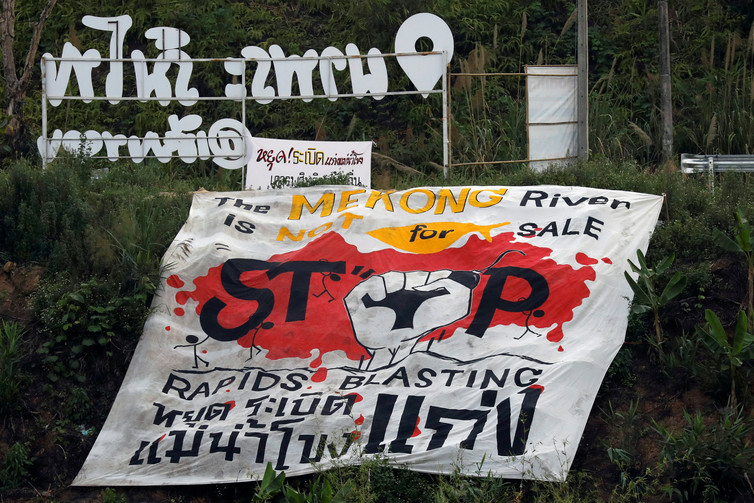 <p>A protest banner against rapids blasting in the Mekong River at the border between Laos and Thailand [image by: Jorge Silva/Reuters]</p>