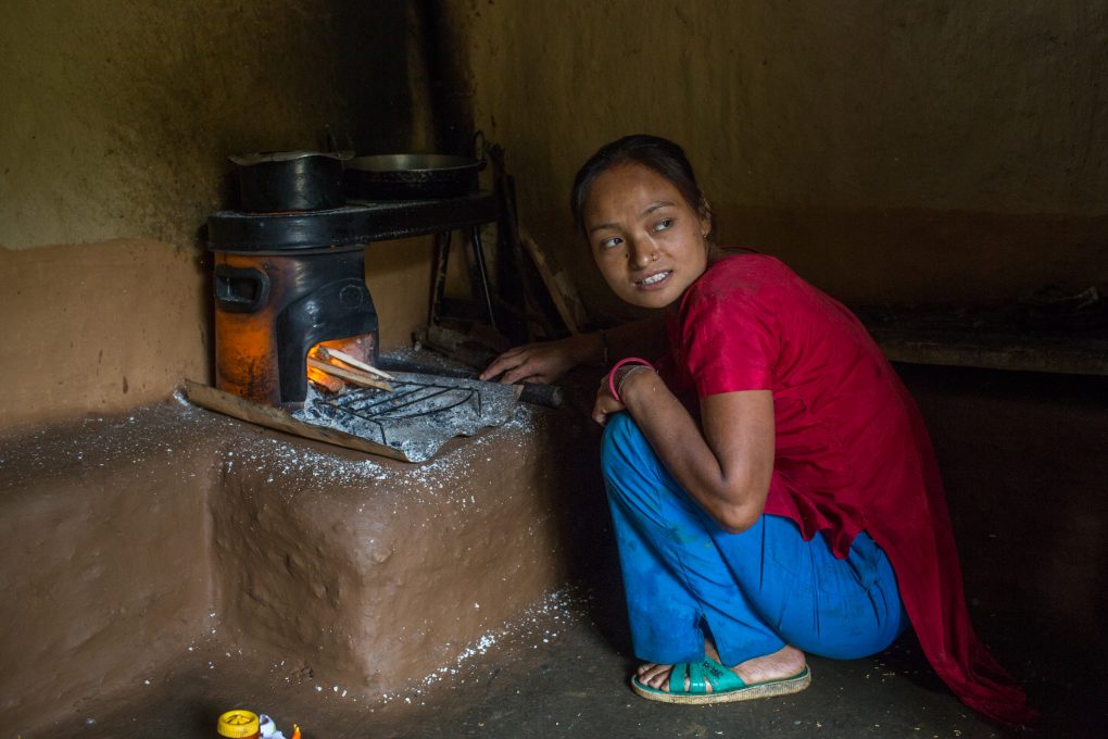 <p>Rupa Tamang cooks food on her improved cookstove. [Image: Nabin Baral]</p>