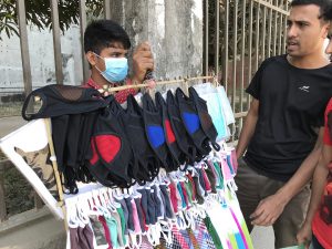<p>Hawkers have seen the need for air-pollution masks as another sales opportunity for their inventory (Image: Kamran Reza Chowdhury)</p>
