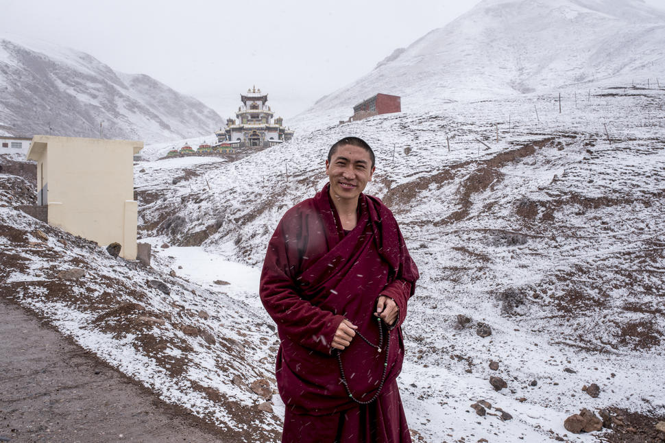 environmental activist, Lama Trinli Gyatso, stands outside his home in the mountains surrounding Zado, Tibet (Qinghai, China).
