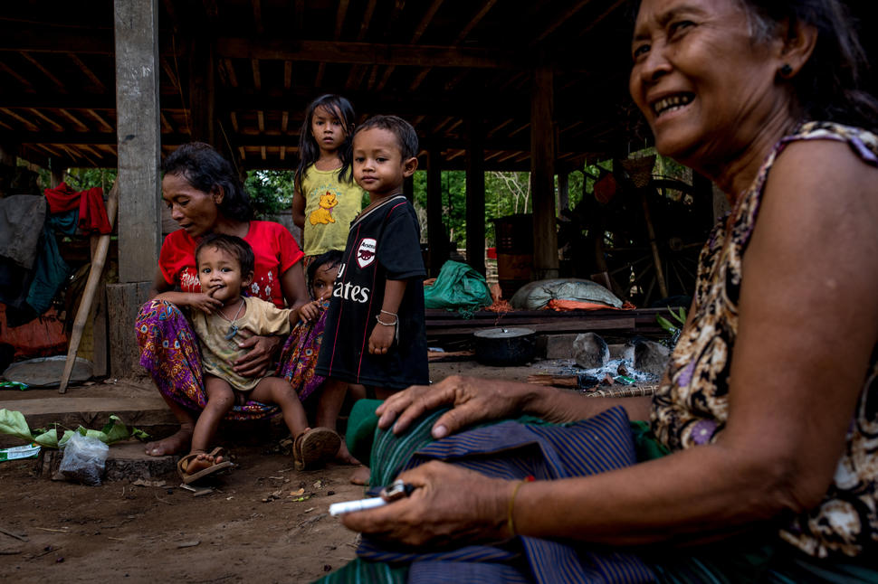 A Bunong family in Kbla Romeas village, northeastern Cambodia. The Bunong are an ethnic minority tribe who inhabit parts of northeastern Cambodia, and rely heavily on natural resources to sustain their community. The Sesan II dam, if built, will displace multiple minority tribes, as well as substantially impact their ability to farm and fish. The community is currently divided; roughly half the villagers have accepted a resettlement compensation package, while the other half staunchly refuses to leave their land.