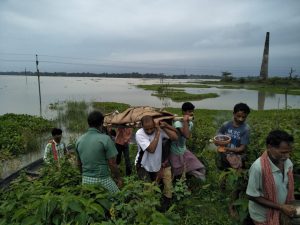 <p>Locals carrying a body of a flood victim in a funeral [image by: Madhav Bhattacharya]</p>