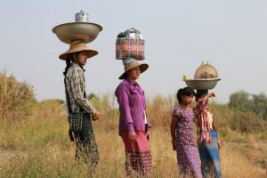 Women in Chaung, Myanmar delivering lunch to farmers