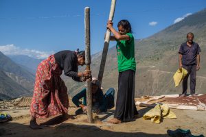 <p>Women in Kapri village Bajura, western Nepal, preparing millet for use after harvest [Image by Nabin Baral]</p>