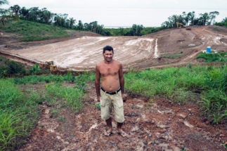 A man stands in front of a construction site