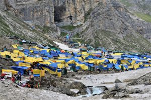 <p>The Amarnath cave and the market near the shrine. Besides the market, there is a large langar (food canteen) which provides food to the pilgrims during the day; and dinner for those who stay at the site for the night [image by: Athar Parvaiz]</p>