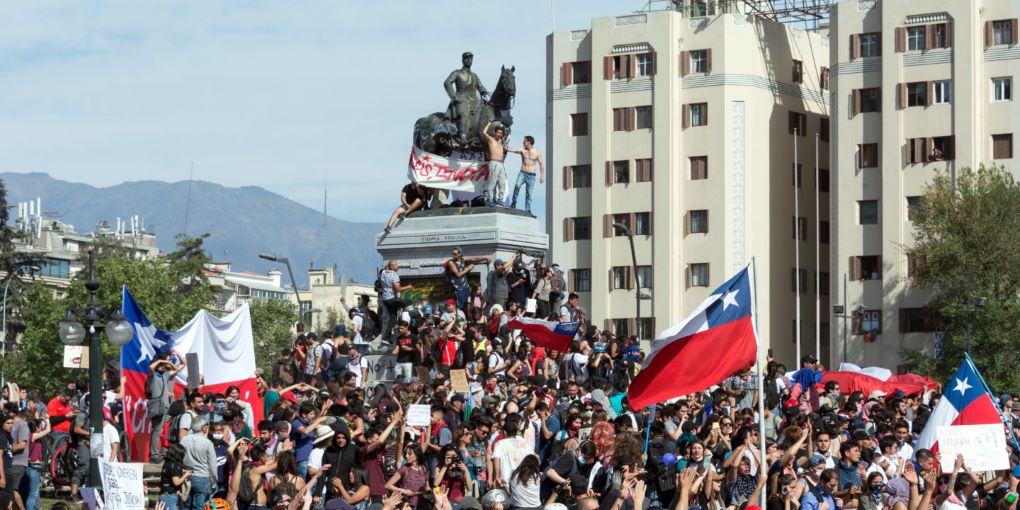<p>Protests in Chile presented insurmountable challenges for Piñera&#8217;s government ahead of the APEC Summit and COP25 (image: <a href="https://upload.wikimedia.org/wikipedia/commons/9/97/Protestas_en_Chile_20191022_07.jpg">Carlos Figueroa</a>)</p>