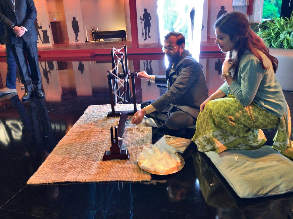 <p>Prakash Javadekar, India’s Minister for Environment, Forests and Climate Change, at the charkha at the India pavilion during the UN climate summit in Madrid [image by: Joydeep Gupta]</p>