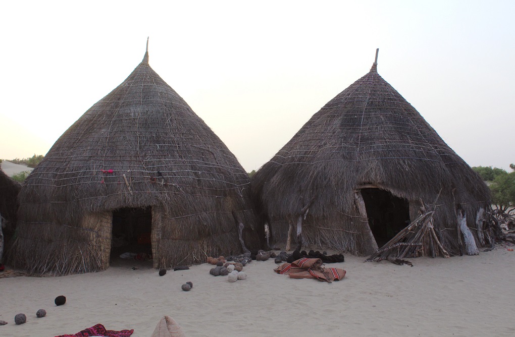 Many of the people that live in the area can only afford huts like these [image by: Akhtar Hafeez]