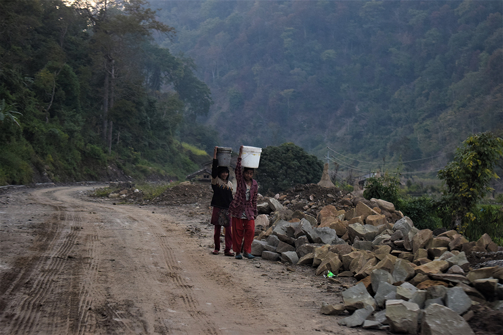 Women and girls spend hours every day, clambering down steep hillsides to fetch water from the Mahakali river, and then walking up with laden vessels