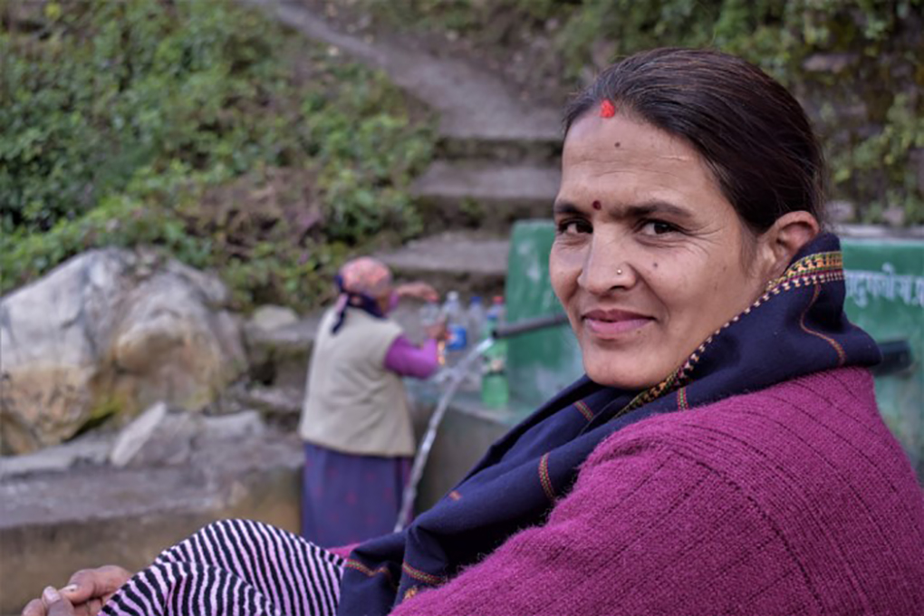 <p>This spring in a village of Nepal’s Darchula district was repaired by the women of India and Nepal working together; women from India cross the Mahakali every day and come to the spring for water; Chandra Samantha sits by [image by: Minket Lepcha]</p>