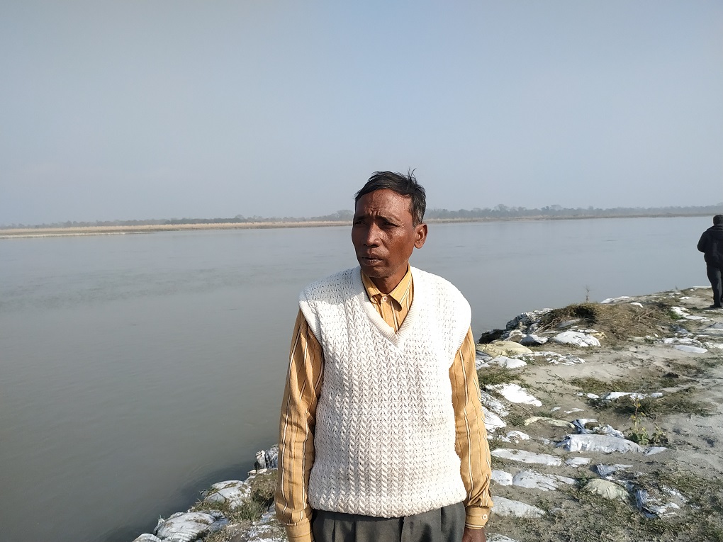 Narayan Chaudhary, points out, “The government settled us here, but the problem of soil erosion due to the river is now ruining everything." [image by: Manoj Singh]