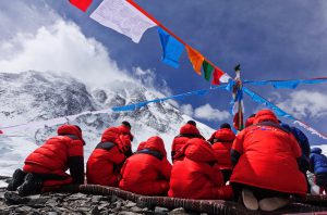 <p>Climbers pray for safety at the Advance&nbsp;Base Camp before starting&nbsp;their ascent&nbsp;(Image: Li Jinxue)</p>