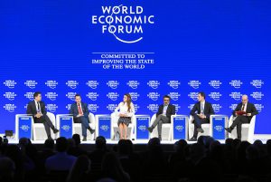 business leaders on stage at the world economic forum in Davos