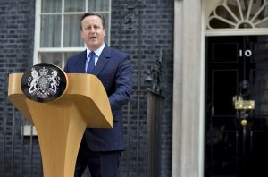 David Cameron standing on a podium