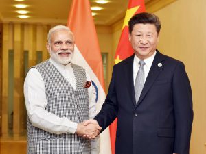 China and India president. Narendra Modi and Xi Jinping shake hands