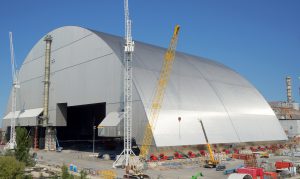 <p>With an arch-shaped steel structure now positioned over the main reactor disaster site, the Chernobyl exclusion zone can be made safe for uses such as renewable energy (Image: EBRD)</p>