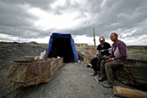 two men sit by the abandoned Nilaikh coal mine near Ulan Bator