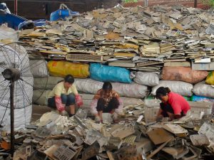 Women sort through waste plastics on the outskirts of Guangzhou