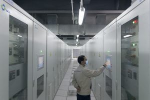 <p>A Golden Concord employee walks through the company&#8217;s energy storage plant in Suzhou, April 3, 2020. (Image: Kevin Schoenmakers)</p>