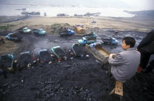 <p>Mengfa Coal Company trucks and tractors deposit large piles of coal by the bank of the Ulan Moron River. (Image: Alamy)</p>