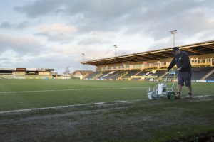 <p>Forest Green&#8217;s groundsman Adam Witchell marks the byline before a match (Image: Chris Davy/China Dialogue)</p>