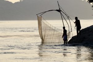 <p>Fishermen on the Brahmaputra, a river that winds through four countries (Image: Sumit Vij)</p>