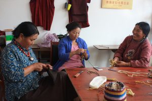 Women from Maozhuang making yak felt slippers. Cooperatives can help communities develop sustainably and provide a source of funds for environmental protection (Image by Wang Yan)