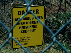 <p>&quot;Danger, Hazardous Area&quot;&nbsp;sign as seen through chain link fence at the Love Canal containment zone. (Image by EPA)</p>