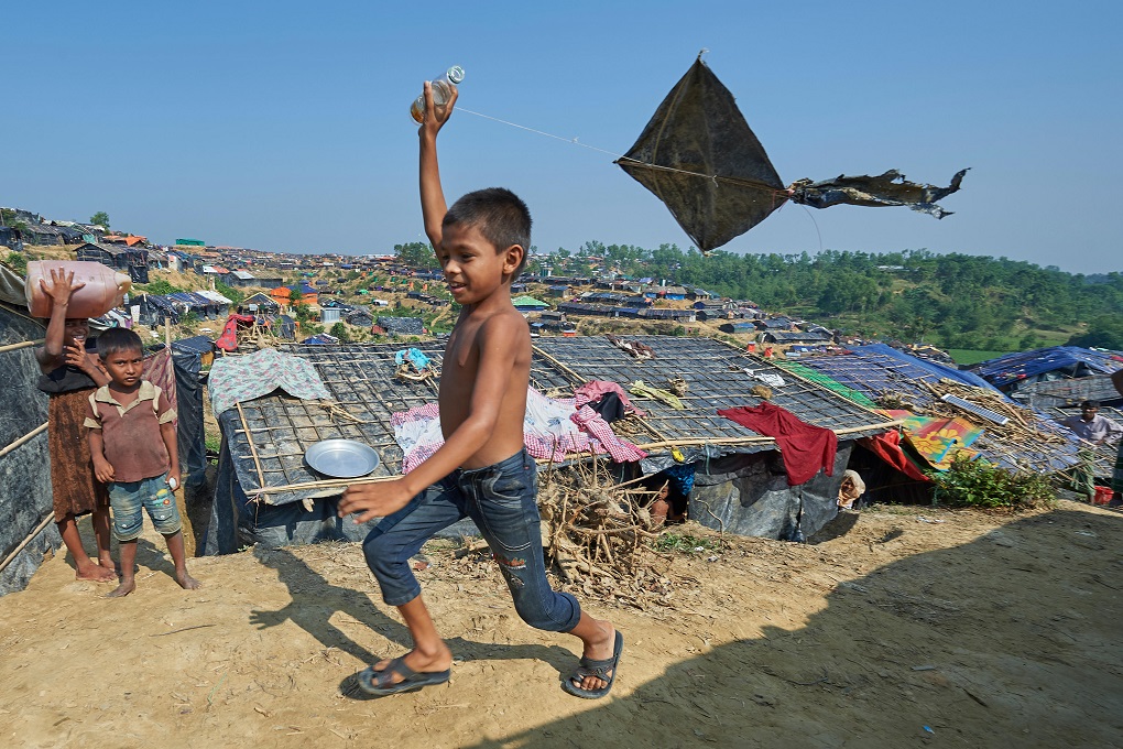 A Rohingya boy flies a kite in the Jamtoli Refugee Camp