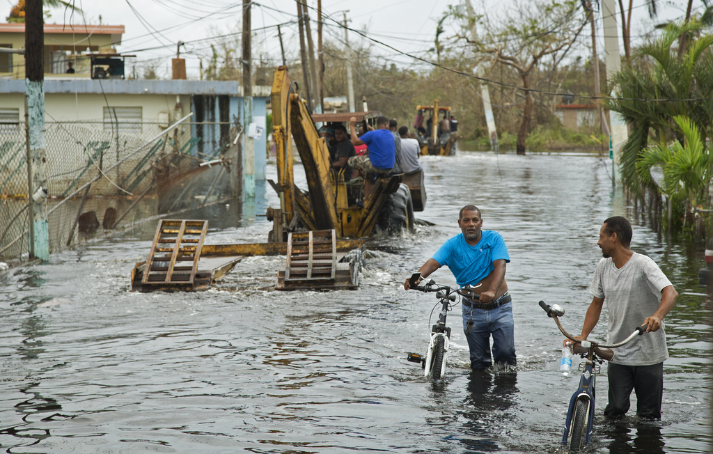 <p>People in Miñi Miñi, Puerto Rico, use diggers to help get their neighbours out of flooded areas. Loíza is a coastal municipality that got severely affected by Hurricane Maria (Image: Yuisa Rios/FEMA)</p>