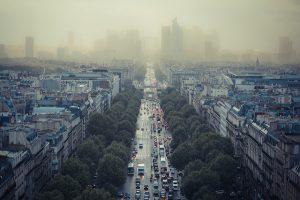 The Avenue des Champs-Élysées in Paris with a smoggy La Défense in the background