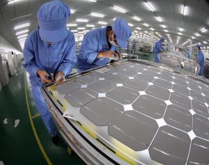<p>Solar powered photovoltaic cells are assembled by workers at a&nbsp;factory in Dezhou, Shandong province&nbsp;(Image: Alamy)</p>