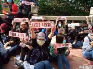Demonstrators in heyuan holding signs at protest against Guangdong coal-fired power plant