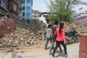 Kathmandu residents walk past a temple that collapsed in April 25 earthquake (Image by Ramesh Bhushal)