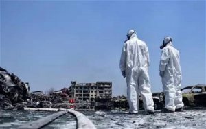 two workers who are part of specialist chemicals unit at the scene of last week's explosions in Tianjin, where the release of highly-toxic sodium cyanide is the main concern (Image by weibo)