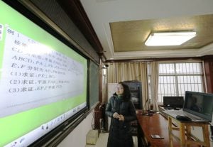 <p>A middle school teacher in south China gives a lesson to an empty classroom via internet. Students remain isolated at home as part of efforts to prevent the spread of the coronavirus. (Image: Alamy)</p>